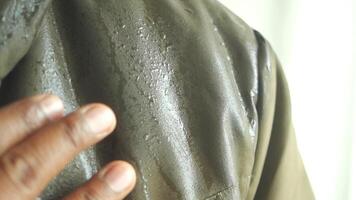 Water droplets gather on a jacket while being outside in the rain. video