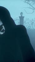 3d render. Dark hooded Grim Reaper with glowing red eyes holds scythe in spooky cemetery with gothic crosses and iron gates. Atmospheric horror scene with fog and erie lighting. Halloween. video