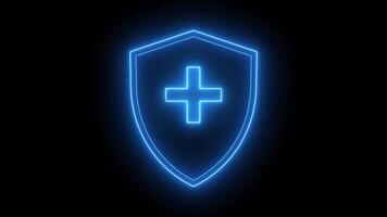 Glowing neon shield with cross on black background video