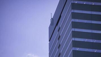 A timelapse of moving cloud reflecting the building at the city telephoto shot panning video