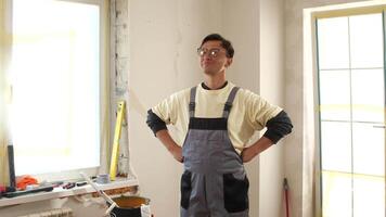 A man in overalls standing in a room video