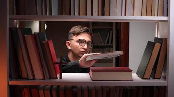 Priest putting book on bookshelf in church library video