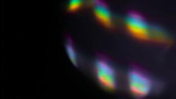Abstract Rainbow Prism Light Flare Overlay Effect on Black Background Creating a Dreamy and Festive Atmosphere Through Vibrant and Holographic Colors. seamless looping 4k animation background video