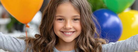 A young girl is smiling with her arms up in the air photo