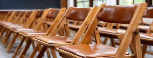 Rows of wooden chairs in a classroom photo