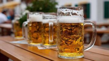 Three large beer mugs sit on a wooden table photo