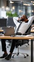 A man in a business suit is sitting in an office chair photo