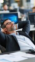 A man in a suit and glasses is sleeping in an office photo