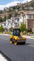 A yellow construction vehicle driving down a street photo