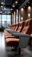 Rows of seats in a theater with a large window photo