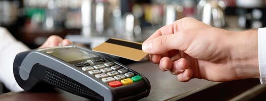 A person is holding a credit card to a credit card reader photo