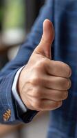 A man in a suit giving the thumbs up photo