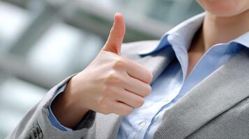 A woman in a business suit giving the thumbs up photo