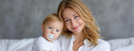 A woman holding a baby and smiling photo