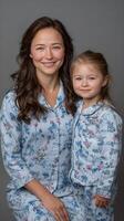 A woman and her daughter in matching pajamas photo
