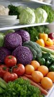 A refrigerator filled with fresh vegetables and fruits photo