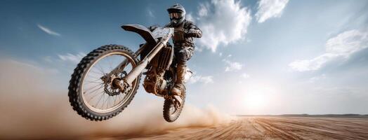 Motocross rider on dirt bike in the air photo