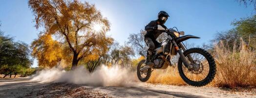 A person riding a dirt bike on a dirt road photo