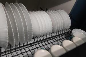 Dishes Drying in a Kitchen Rack After a Wash in a Modern Home photo