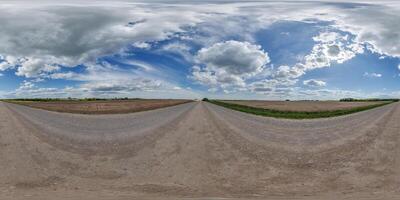 hdri 360 panorama view on gravel road among fields with clouds in sky in equirectangular full seamless spherical projection, ready for VR AR or sky dome replacement photo