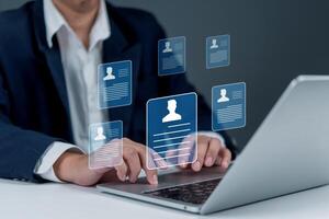 A business man using a laptop with icons on the screen photo