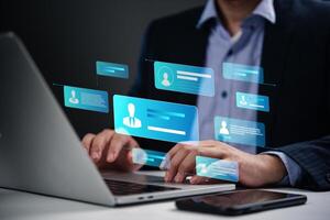 Man using laptop with social icons on screen photo