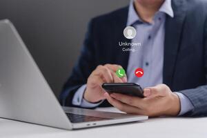Businessman using his smartphone to make a call photo