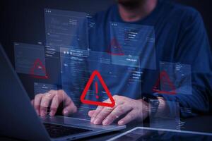 A person is typing on a laptop with a red triangle photo