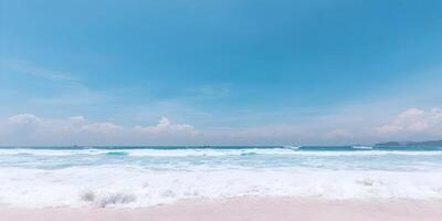 Ocean Waves Crashing on Sandy Beach Under Blue Sky with Clouds photo