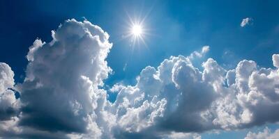 Sun rays piercing through fluffy clouds on a calm blue sky day photo