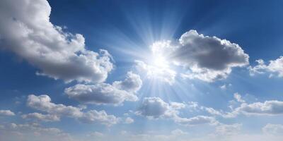 Bright sunbeams filtering through soft white clouds in the sky photo