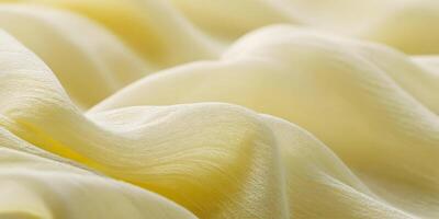 Pale Yellow Fabric Texture Close Up Soft Draped Chiffon Material Background photo