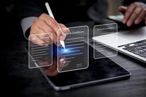 Businessman using tablet to write on screen with pen and finger photo