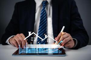 Businessman using tablet with graph and business chart photo