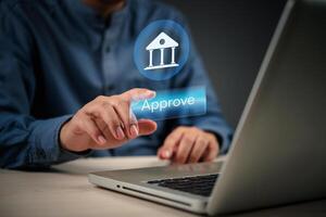 Man using laptop with approval button on screen photo