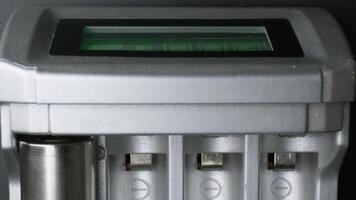 Close-up of Modern Battery Charger with Digital Display in Controlled Indoor Environment Charging AA Batteries video