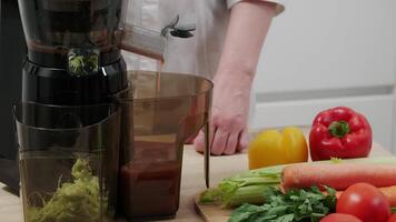 Fresh Vegetable Juice Preparation in Modern Kitchen with Juicer and Colorful Ingredients on Counter video