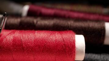 Close-up of Sewing Needles Inserted in Colorful Spools of Thread in Tailoring Workshop Environment video