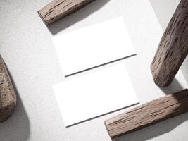 Simple business card on a stone block with wooden logs placed creatively for a unique design. photo