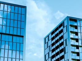 Angular office blocks with grid windows mirror clouds photo