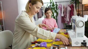 Creative sewing session with mother and daughter in cozy workspace video