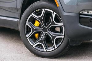 Close-up of a modern car wheel. The details of the tire tread and rim are clearly visible, emphasizing the technology and style of the vehicle photo