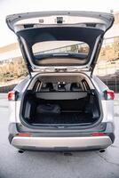 Gray modern car with open empty trunk. Travel. photo