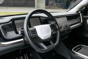 Close-up of a car steering wheel in a modern new car. The interior of a stylish new car. photo