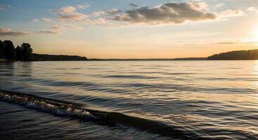 Sunset over calm water and shore photo