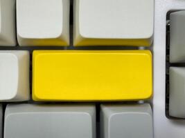 Big yellow Enter button on mechanical white keyboard, business concept, for advertising, for banners photo