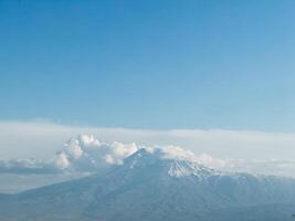 Mount Ararat with snow capped clouds photo