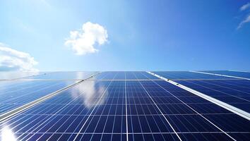 Solar panels on a blue sky with clouds photo
