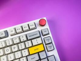 Gaming keyboard, isolated on purple background, copy space, flay lay photo