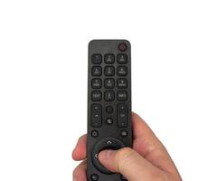 White male hand on white background presses buttons on TV remote control, switches TV channels with remote control, for banners, for TV advertising. Copy space, flay lay, top view. photo